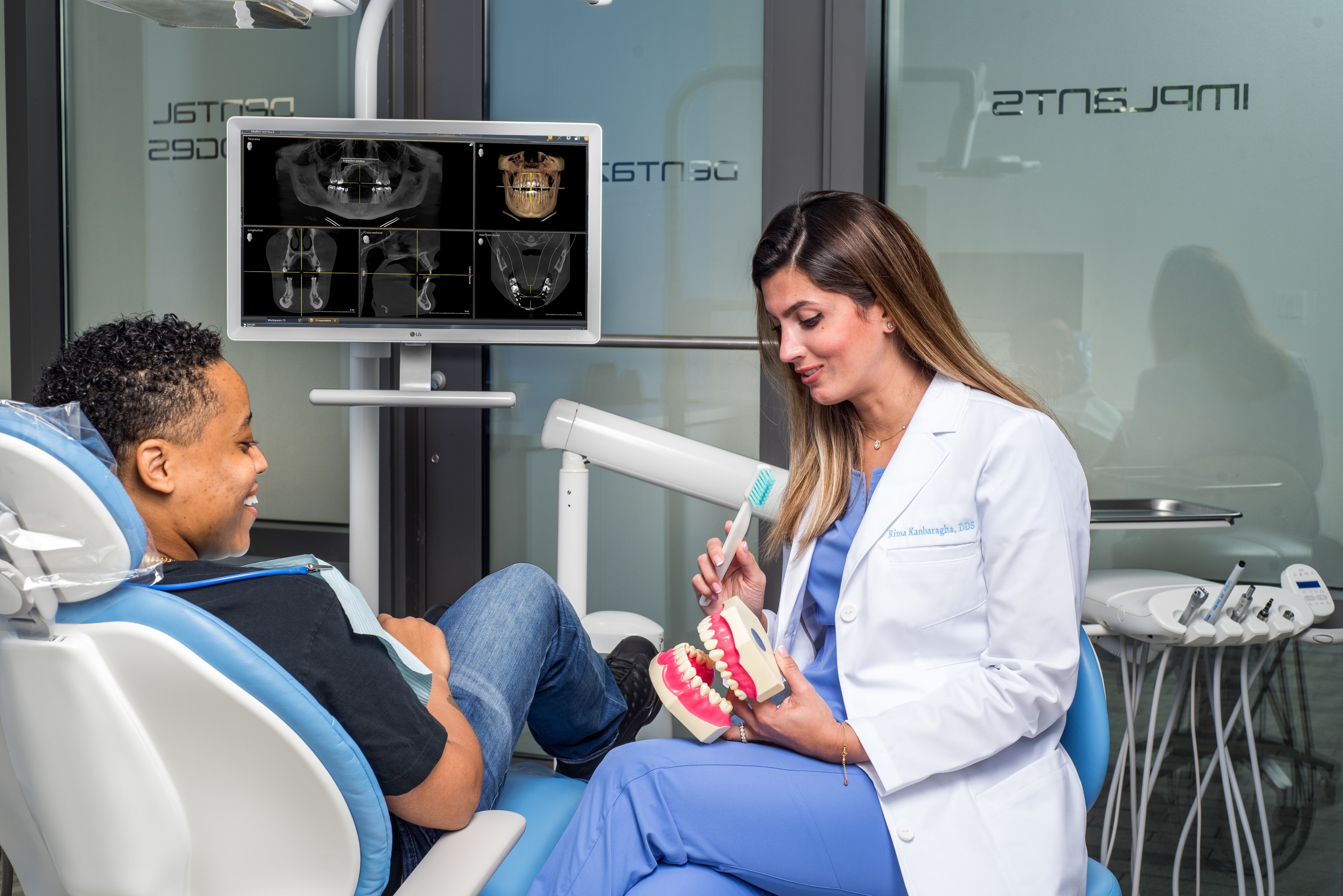 Doctor in white coat with a patient in a modern dental office